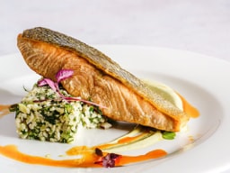 An eloquently presented dish of seared salmon fillet.