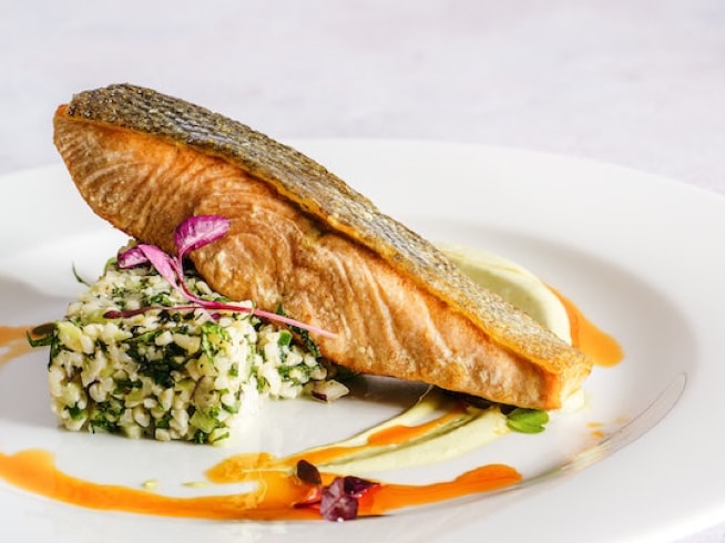 An eloquently presented dish of seared salmon fillet.